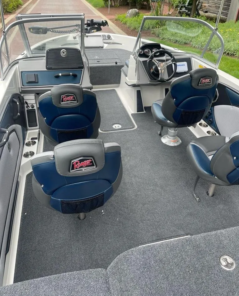 Slide: The Image of 2025 Ranger 1850MS boat interior with blue seats and steering console. - 5