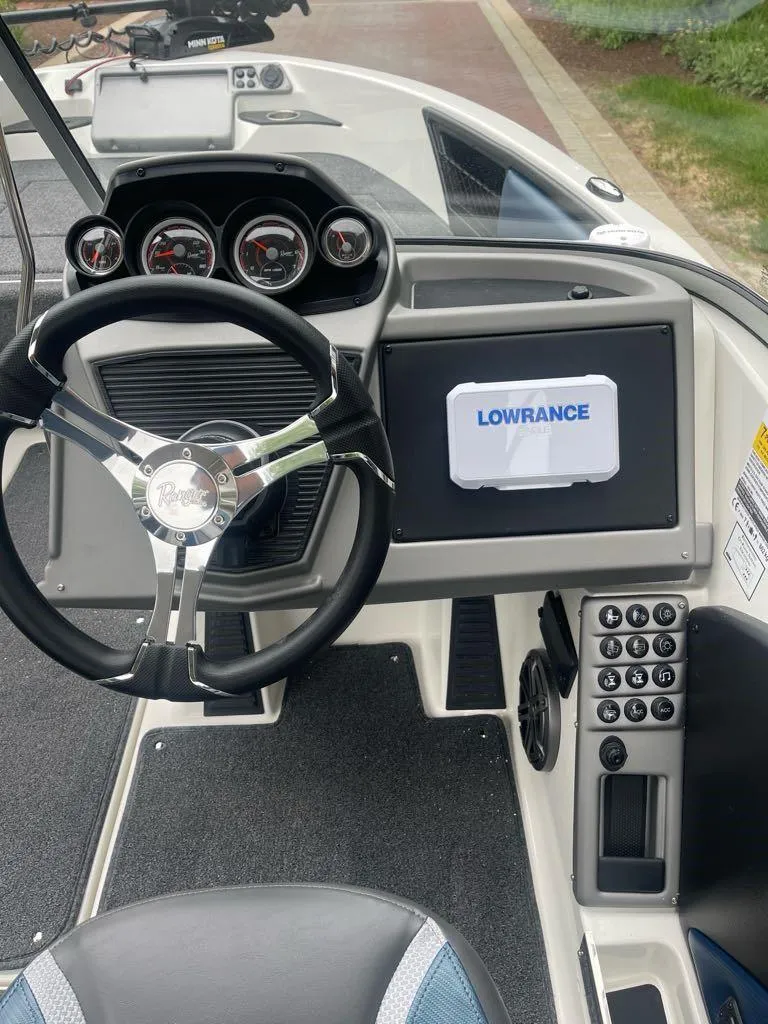 Slide: The Image of 2025 Ranger 1850MS boat dashboard with Lowrance display and modern steering wheel. - 6
