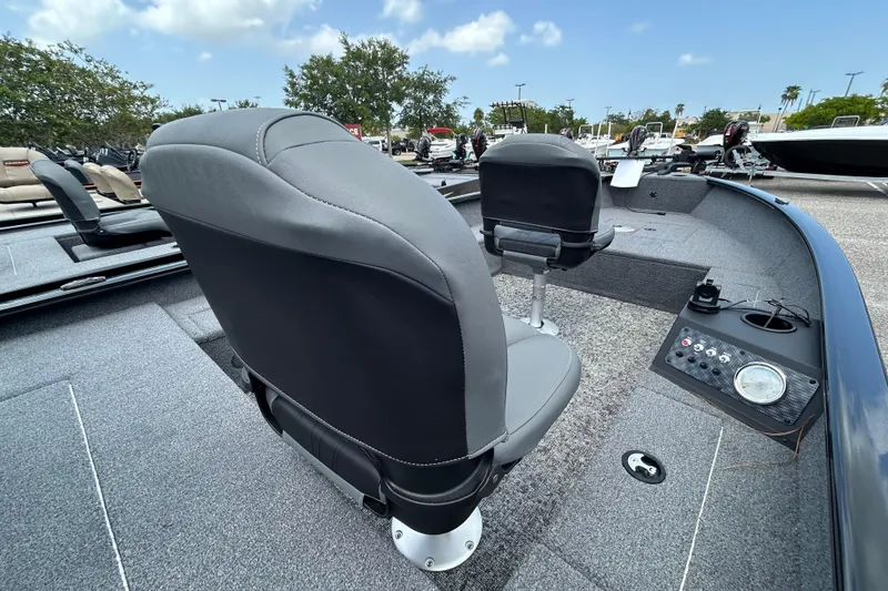 Slide: The Image of 2025 Tracker Super Guide V-16 T boat interior with gray seating and control panel. - 4