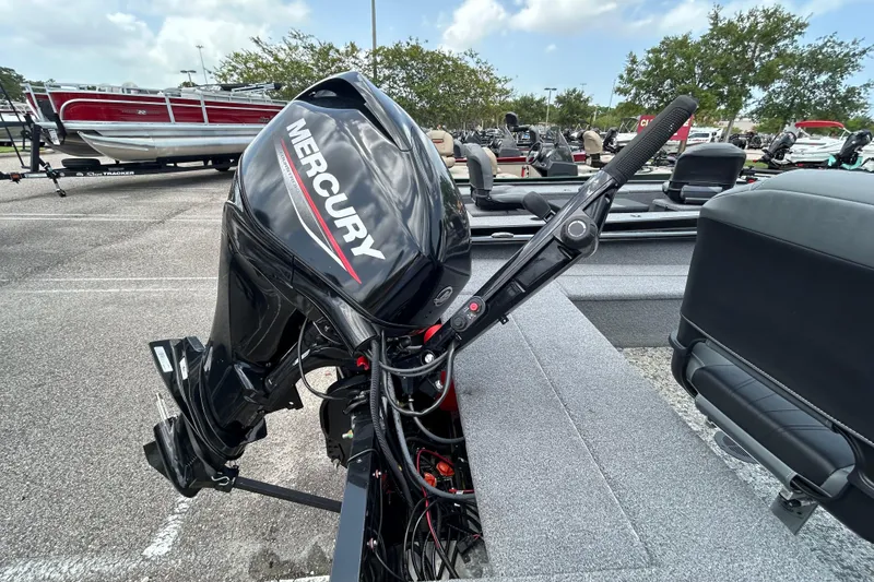 Slide: The Image of 2025 Tracker Super Guide V-16 T with Mercury outboard motor in a parking lot. - 3