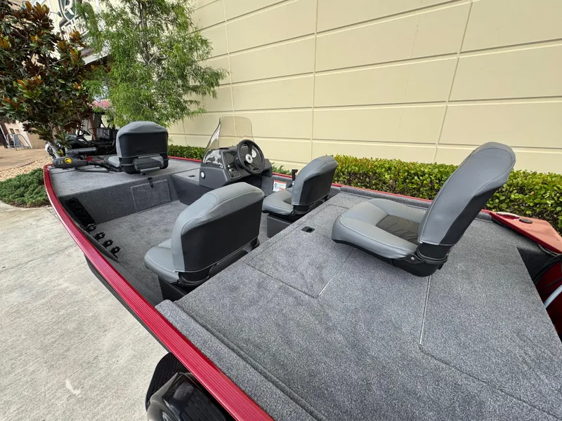 Slide: The Image of 2025 Tracker Bass Tracker Classic XL boat with gray seating and spacious deck. - 2