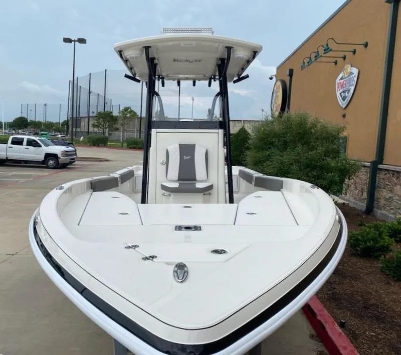 Slide: The Image of 2025 Ranger 2510 Bay boat parked outdoors near a building. - 3