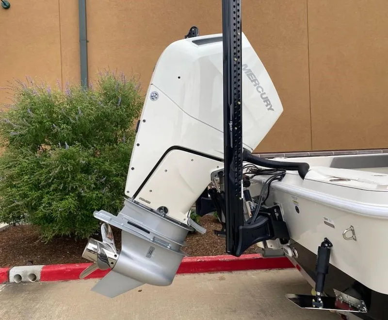 Slide: The Image of 2025 Ranger 2510 Bay boat with Mercury outboard motor, parked outdoors. - 5
