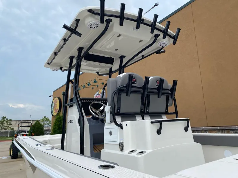 Slide: The Image of 2025 Ranger 2510 Bay boat with T-top and dual seats, docked outdoors. - 6
