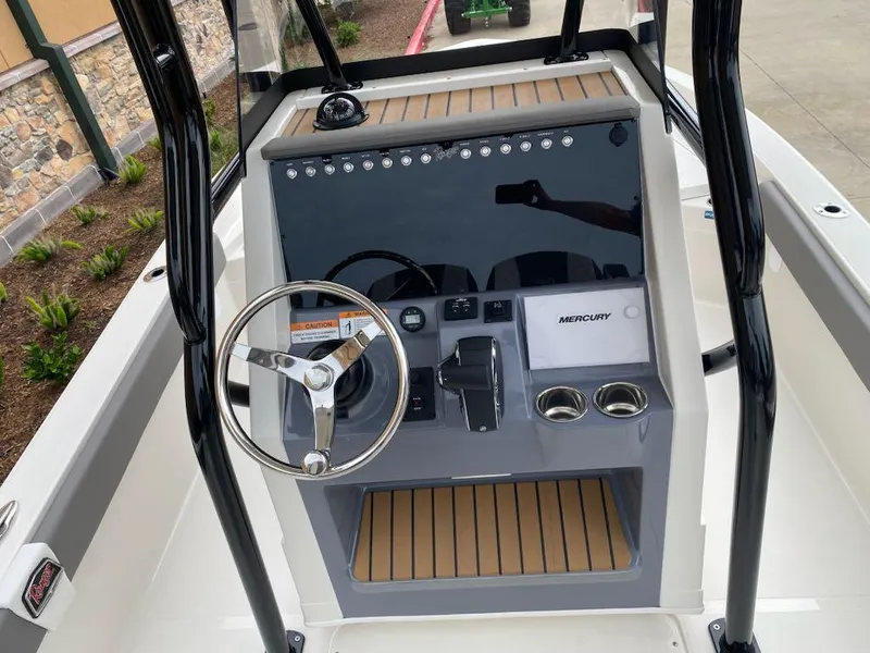 Slide: The Image of 2025 Ranger 2510 Bay boat console with steering wheel and Mercury controls. - 7