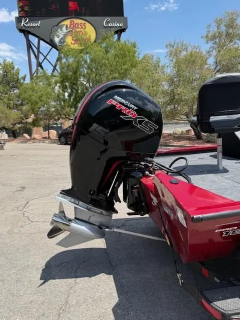 Slide: The Image of 2025 Tracker Pro Team 195 Tournament Edition boat with Mercury Pro XS engine, parked near Bass Pro Shops. - 6