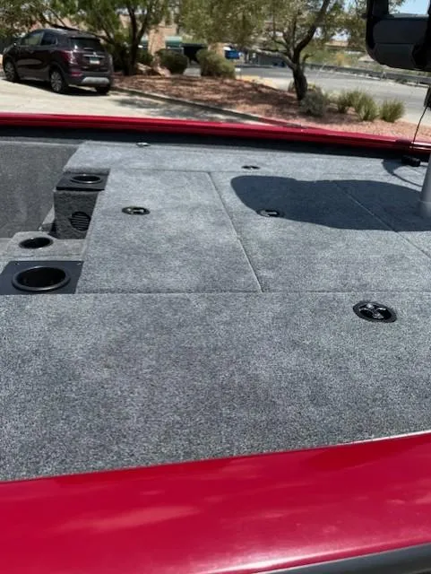 Slide: The Image of 2025 Tracker Pro Team 195 Tournament Edition boat deck with gray carpeting and storage compartments. - 9