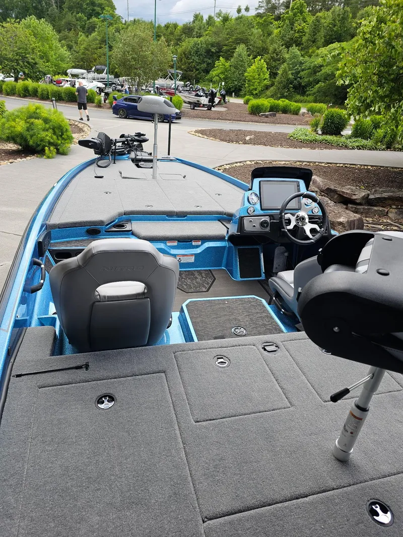 Slide: The Image of 2025 Nitro Z21 XL Pro boat with modern interior and sleek design in a scenic setting. - 3