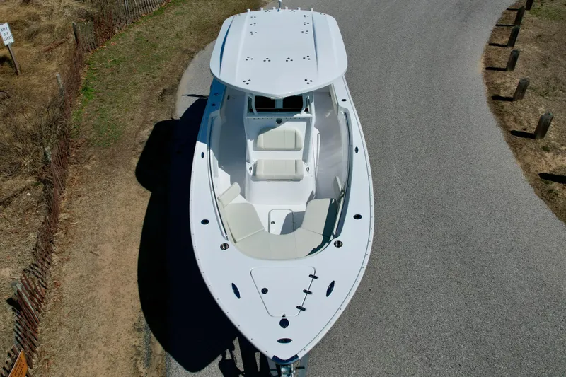 Slide: The Image of 2025 Cape Horn 24 XS boat, aerial view, parked on a road. - 10