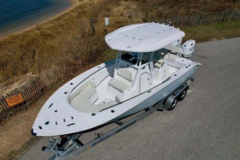 Slide: The Image of 2025 Cape Horn 24 XS boat on trailer near beach, aerial view. - 11