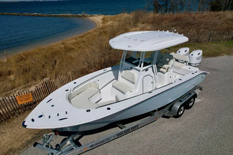 Slide: The Image of 2025 Cape Horn 24 XS boat on trailer by the shoreline, ready for adventure. - 15