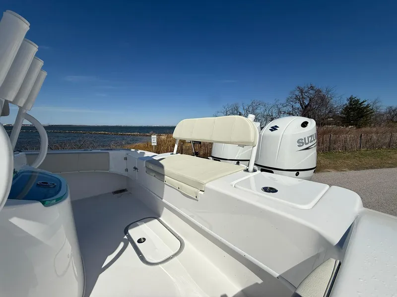 Slide: The Image of 2025 Cape Horn 24 XS boat with Suzuki engine, docked by a scenic waterfront. - 22