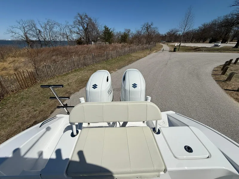 Slide: The Image of 2025 Cape Horn 24 XS boat with dual Suzuki outboard motors on a scenic road. - 23