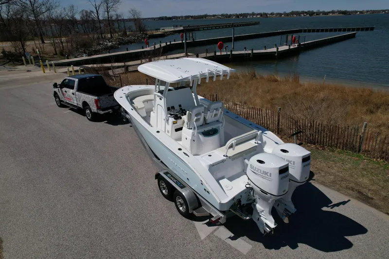 Slide: The Image of 2025 Cape Horn 24 XS boat on trailer near waterfront, ready for launch. - 4