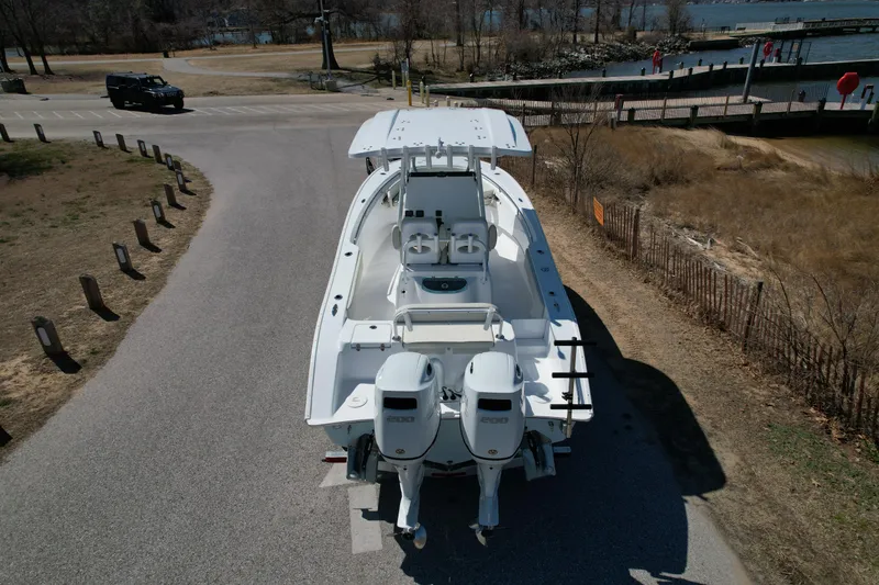 Slide: The Image of 2025 Cape Horn 24 XS boat with dual engines on a road near a waterfront. - 5