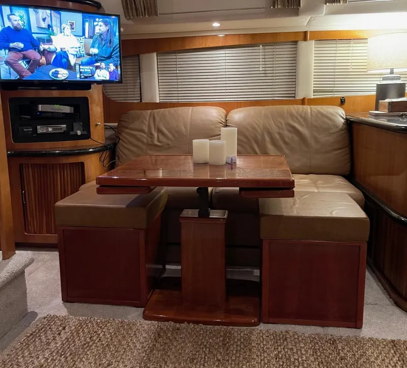 Slide: The Image of Interior of 2002 Carver 396 Motor Yacht with cozy seating and entertainment setup. - 10