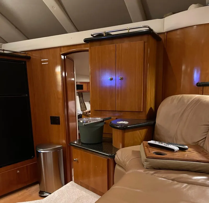 Slide: The Image of Interior of 2002 Carver 396 Motor Yacht with wood cabinetry and leather seating. - 11