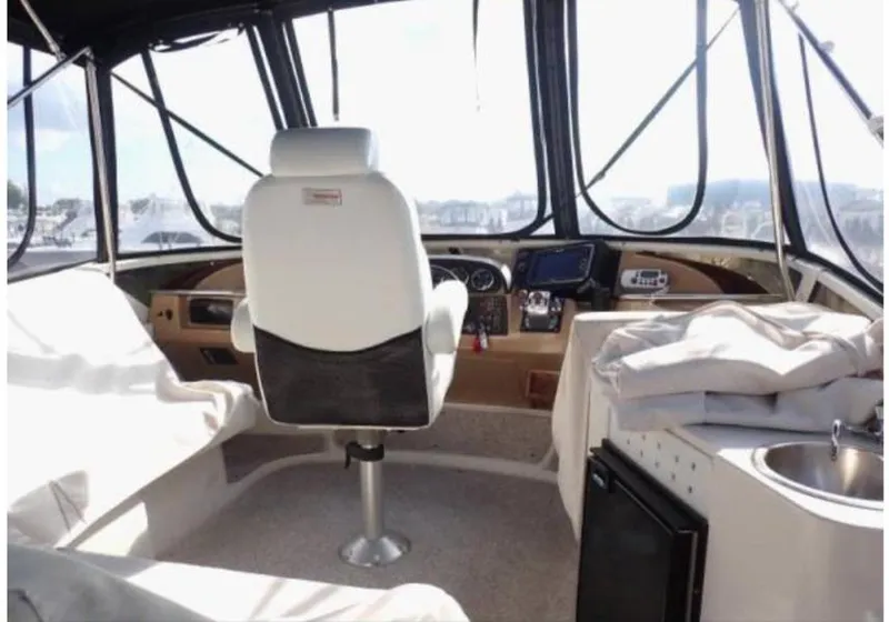 Slide: The Image of Interior of 2002 Carver 396 Motor Yacht with captain's chair and navigation equipment. - 18