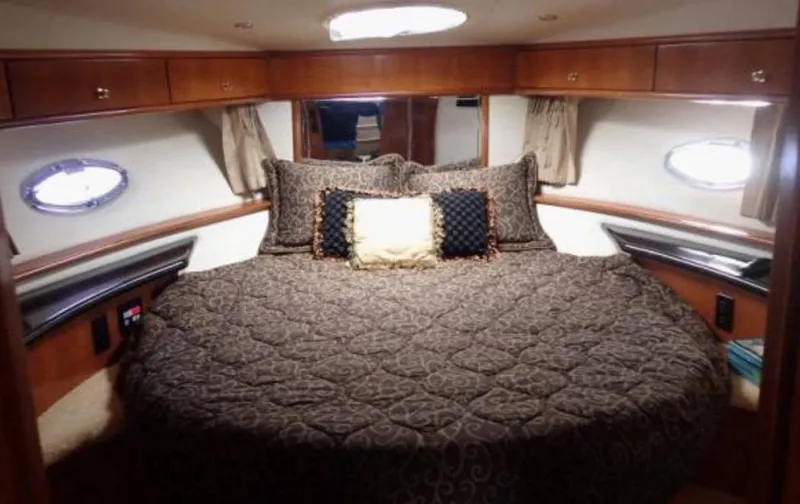 Slide: The Image of Luxurious bedroom in 2002 Carver 396 Motor Yacht with elegant bedding and wood accents. - 19