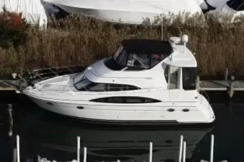 Slide: The Image of 2002 Carver 396 Motor Yacht docked in a marina, side view. - 5