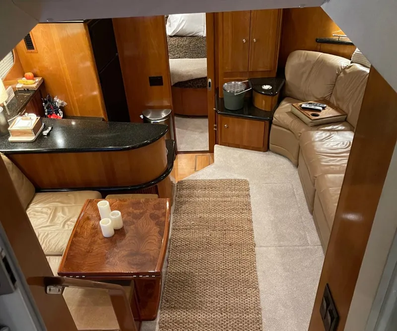 Slide: The Image of Luxurious interior of 2002 Carver 396 Motor Yacht with leather seating and wooden accents. - 8