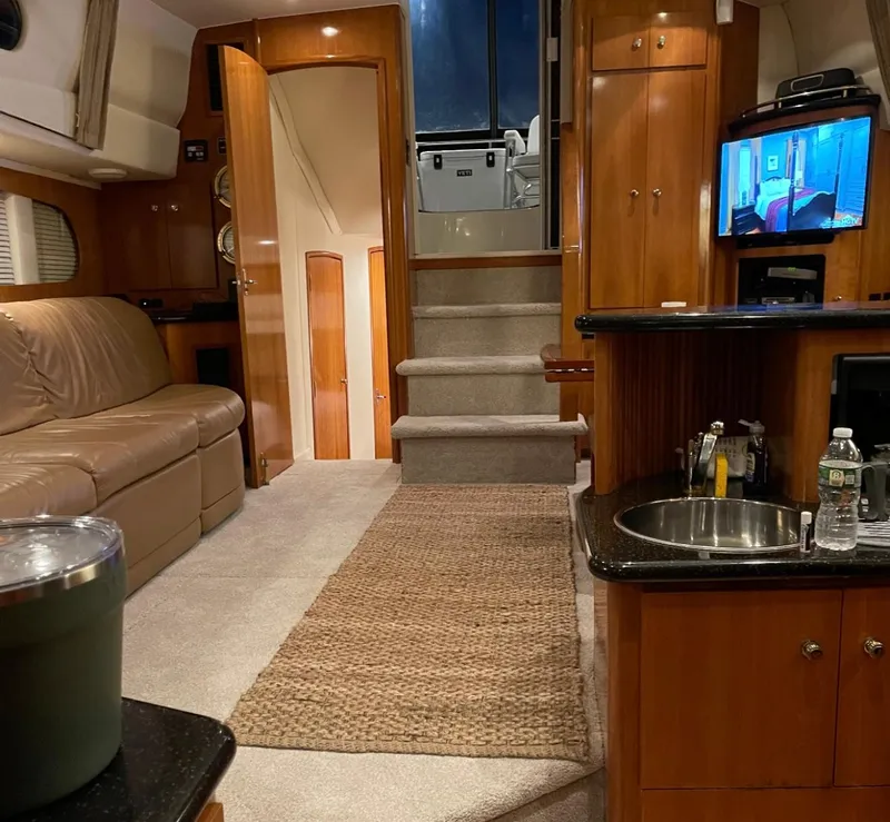 Slide: The Image of Interior of 2002 Carver 396 Motor Yacht with cozy seating and modern amenities. - 9