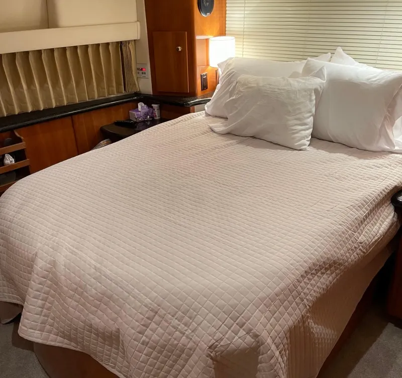 Slide: The Image of Luxurious bedroom interior of 2002 Carver 396 Motor Yacht with cozy bedding. - 13