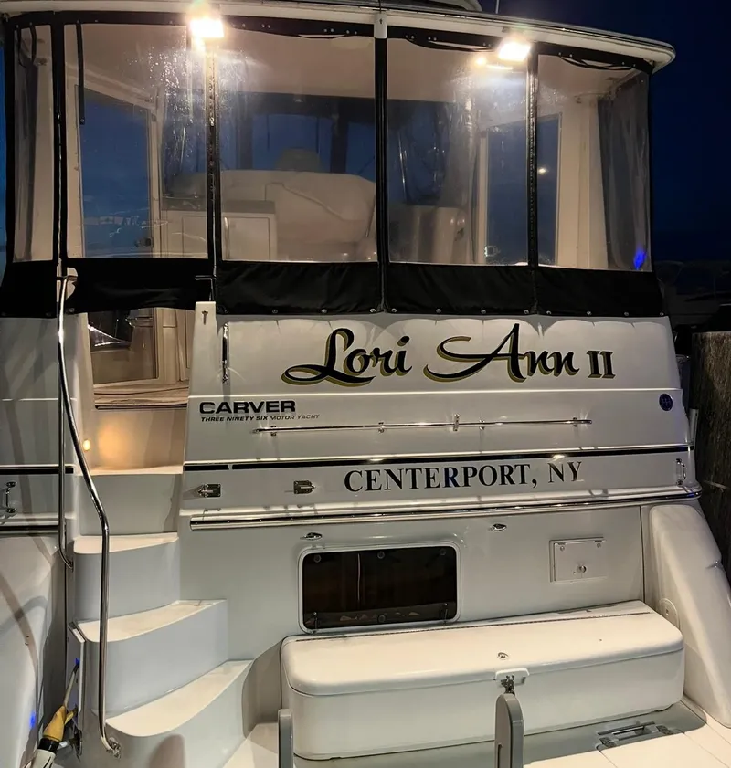 Slide: The Image of 2002 Carver 396 Motor Yacht docked at night, featuring illuminated name "Lori Ann II". - 7