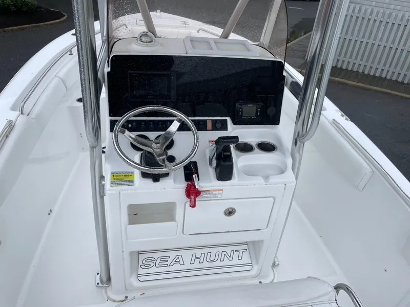 Slide: The Image of 2017 Sea Hunt 21 CC boat console with steering wheel and controls. - 10