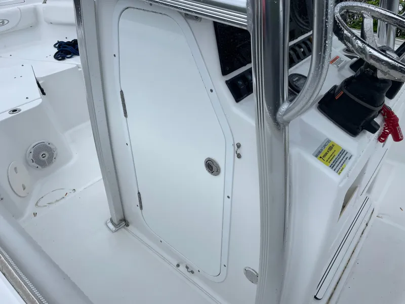 Slide: The Image of 2017 Sea Hunt 21 CC boat console with steering wheel and storage compartment. - 14