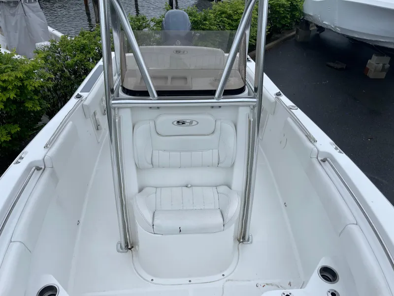 Slide: The Image of 2017 Sea Hunt 21 CC boat interior with white seating and stainless steel railings. - 16