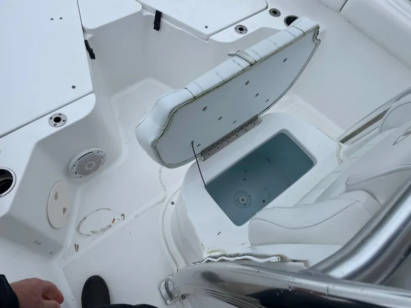 Slide: The Image of 2017 Sea Hunt 21 CC boat interior with open storage compartment. - 19