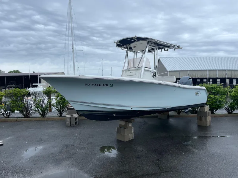 Slide: The Image of 2017 Sea Hunt 21 CC boat on blocks, marina background, overcast sky. - 21