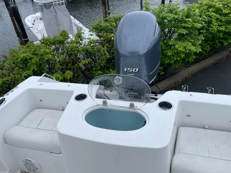 Slide: The Image of 2017 Sea Hunt 21 CC boat with Yamaha 150 engine, featuring seating and livewell. - 4