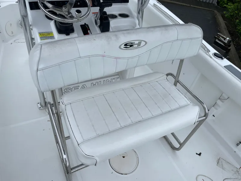 Slide: The Image of 2017 Sea Hunt 21 CC boat interior with white seating and steering console. - 7