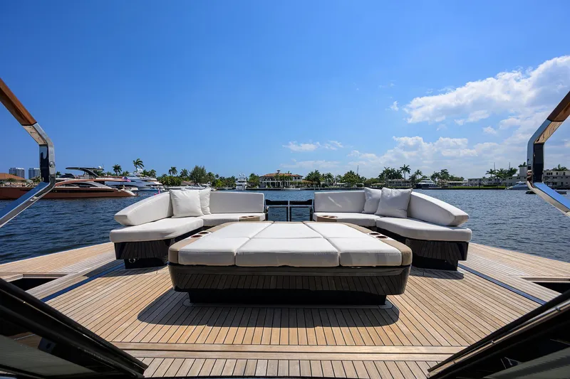 Slide: The Image of Luxurious 2023 Lazzara LSX 67 yacht deck with elegant seating, overlooking serene waters. - 11