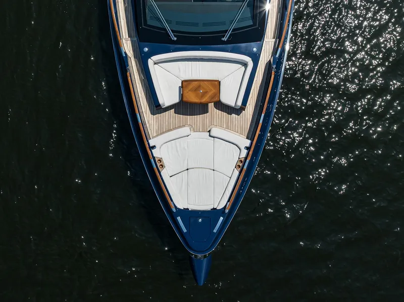 Slide: The Image of 2023 Lazzara LSX 67 yacht, aerial view, sleek design, luxurious deck, on shimmering water. - 12