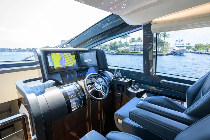 Slide: The Image of 2023 Lazzara LSX 67 yacht cockpit with modern navigation system and luxurious seating. - 17