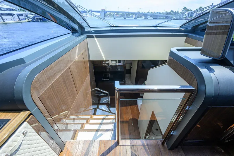 Slide: The Image of 2023 Lazzara LSX 67 yacht interior with modern wood and glass design. - 18