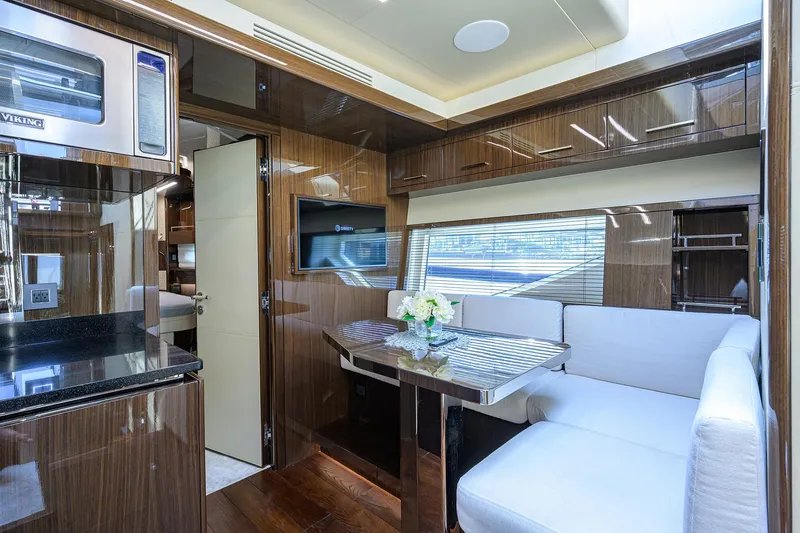 Slide: The Image of Luxurious interior of 2023 Lazzara LSX 67 yacht with modern dining area and sleek finishes. - 21