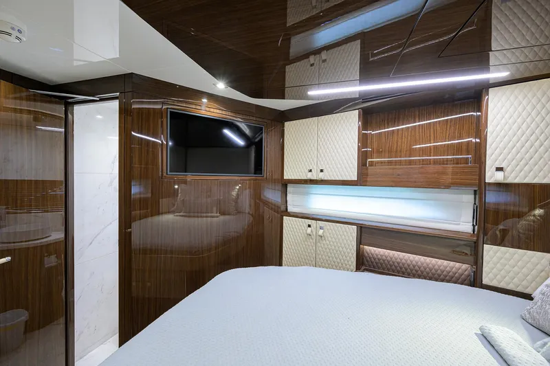 Slide: The Image of Luxurious interior of 2023 Lazzara LSX 67 yacht with modern wood paneling and TV. - 29