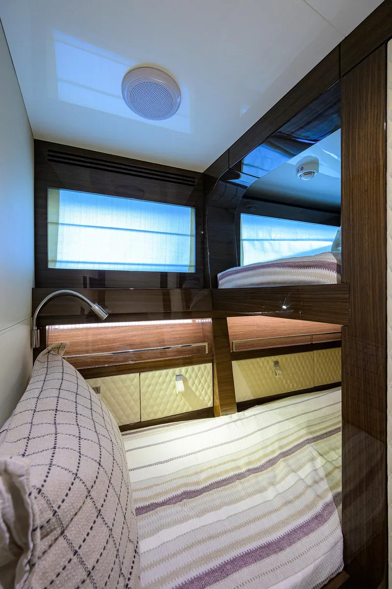 Slide: The Image of 2023 Lazzara LSX 67 yacht cabin with modern design and cozy bedding. - 32
