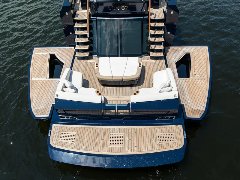 Slide: The Image of 2023 Lazzara LSX 67 yacht with spacious deck and luxurious seating on water. - 6