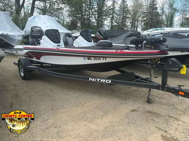 Slide: The Image of 2017 Nitro Z18 boat on trailer at D&R Sports Center, surrounded by trees. - 18