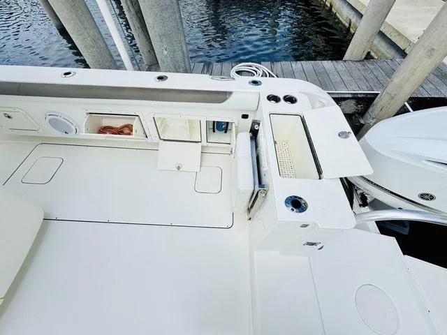 Slide: The Image of 2020 World Cat 32 boat deck with storage compartments and fishing rod holders. - 11
