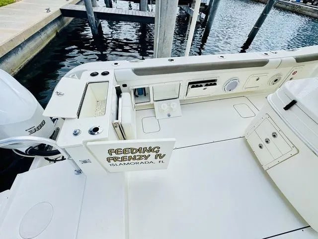 Slide: The Image of World Cat 32 boat deck, 2020 model, docked in Islamorada, FL, with "Feeding Frenzy IV" signage. - 12