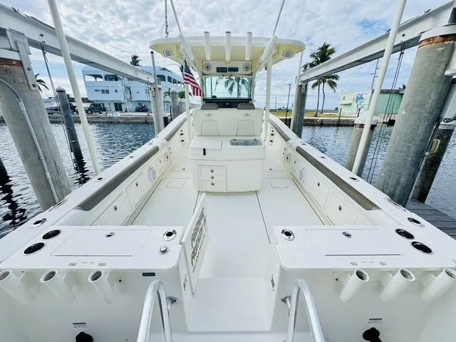 Slide: The Image of 2020 World Cat 32 boat with spacious deck, docked at marina under cloudy sky. - 13