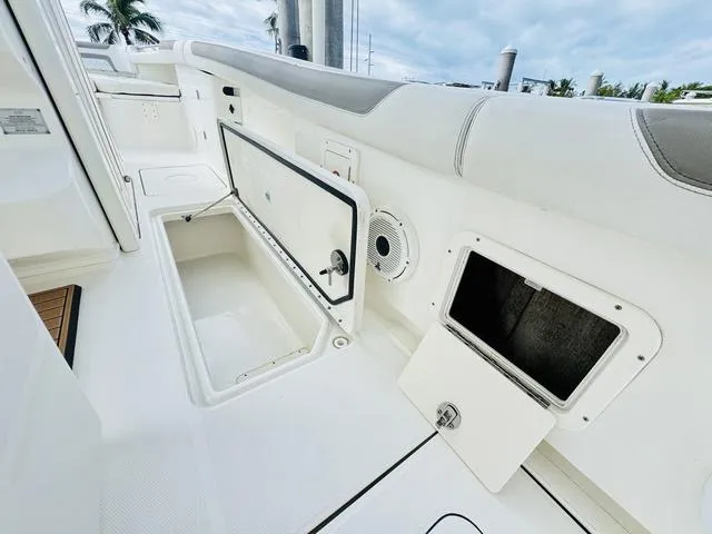 Slide: The Image of 2020 World Cat 32 boat interior with open storage compartments and sleek white seating. - 15