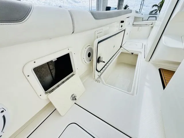 Slide: The Image of Interior view of a 2020 World Cat 32 boat, featuring storage compartments and seating. - 16
