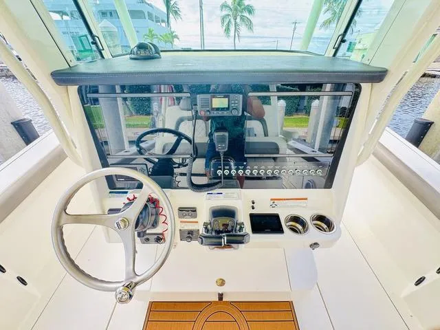 Slide: The Image of Cockpit of 2020 World Cat 32 boat with steering wheel and control panel. - 20